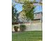 Two story tan home with a wood fence and green grass at 23760 Broadmoor Dr, Parker, CO 80138