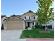 Charming two-story home with a well-maintained lawn and attached two-car garage at 23760 Broadmoor Dr, Parker, CO 80138