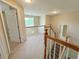 Hallway with carpet and railings that overlooks a spacious living area at 23760 Broadmoor Dr, Parker, CO 80138