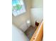 Hallway with wood floors, white doors, and a pendant light fixture above the stairs at 23760 Broadmoor Dr, Parker, CO 80138