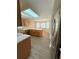 Bright, open kitchen with breakfast bar, nook, wood cabinets, and stainless fridge at 23760 Broadmoor Dr, Parker, CO 80138