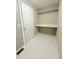 An unfinished laundry room area with vinyl flooring and shelving at 23760 Broadmoor Dr, Parker, CO 80138