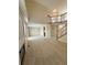 Open living room with a fireplace, staircase, and access to kitchen at 23760 Broadmoor Dr, Parker, CO 80138