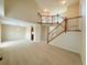 Large living room with a staircase, neutral color palette, and open layout at 23760 Broadmoor Dr, Parker, CO 80138