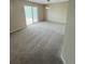 Spacious living room with a sliding glass door to the outdoor deck area at 23760 Broadmoor Dr, Parker, CO 80138