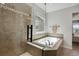 Close-up of the tiled shower and soaker tub at 1558 Wandering Way, Castle Rock, CO 80109