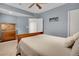 Comfortable bedroom featuring soft blue walls, carpet flooring, and ceiling fan at 1558 Wandering Way, Castle Rock, CO 80109