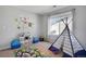 bedroom with a teepee tent, blue seating, and wall decor at 1558 Wandering Way, Castle Rock, CO 80109