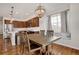 Dining area featuring a wooden table, modern chandelier, and view into the kitchen area at 1558 Wandering Way, Castle Rock, CO 80109