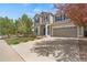 Inviting two-story home with well-maintained lawn, blue shutters, and a spacious driveway leading to the garage at 1558 Wandering Way, Castle Rock, CO 80109