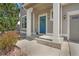 Inviting front porch featuring a blue door with a wreath and white columns supporting the covered entrance at 1558 Wandering Way, Castle Rock, CO 80109