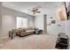 A cozy living room with a large sectional sofa, ceiling fan, and wall-mounted TV at 1558 Wandering Way, Castle Rock, CO 80109