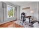 Comfortable home office with a large window, hardwood floors, and a stylish area rug at 1558 Wandering Way, Castle Rock, CO 80109