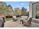 A patio area with outdoor seating, a grill, and a view of the landscaped backyard at 1558 Wandering Way, Castle Rock, CO 80109