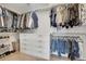 Organized walk-in closet featuring custom shelving, drawers, and hanging rods for ample storage at 1558 Wandering Way, Castle Rock, CO 80109
