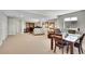 Open basement design with sitting area, desk area, dining table and chairs, with carpeted floors at 8661 S De Gaulle Ct, Aurora, CO 80016