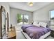 Bright bedroom with neutral walls, plush carpeting, and two large windows at 8661 S De Gaulle Ct, Aurora, CO 80016