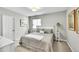 Neutral bedroom featuring a queen bed, matching side tables, and natural light at 8661 S De Gaulle Ct, Aurora, CO 80016