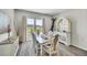 Charming dining room with rustic accents, hardwood floors and bright view of outdoors at 8661 S De Gaulle Ct, Aurora, CO 80016
