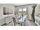 Dining room with large windows, rustic decor, and hardwood floors at 8661 S De Gaulle Ct, Aurora, CO 80016