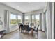 Bright dining room with hardwood floors, modern light fixture, and large windows with scenic views at 8661 S De Gaulle Ct, Aurora, CO 80016