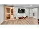 Exercise room featuring wood flooring, television, sauna and workout space at 8661 S De Gaulle Ct, Aurora, CO 80016