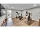 Workout space featuring treadmill, rowing machine, fan bike, wood flooring and weights at 8661 S De Gaulle Ct, Aurora, CO 80016