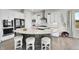 Bright kitchen showcases a large island with seating, white cabinets, and stainless steel appliances at 8661 S De Gaulle Ct, Aurora, CO 80016