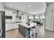 Spacious kitchen with a large island, stainless appliances, and a bright dining area at 8661 S De Gaulle Ct, Aurora, CO 80016