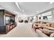 A view of the expansive carpeted living room with an open floor plan at 8661 S De Gaulle Ct, Aurora, CO 80016