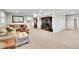 Open floor plan featuring a large carpeted living room with accent furniture at 8661 S De Gaulle Ct, Aurora, CO 80016