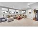 Spacious living room with large sectional sofa, carpeted floor, and multiple windows at 8661 S De Gaulle Ct, Aurora, CO 80016