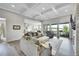 Open-concept living room flows into the kitchen and features a coffered ceiling at 8661 S De Gaulle Ct, Aurora, CO 80016