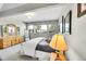 Bedroom with dresser, full-length mirror and bench at 8661 S De Gaulle Ct, Aurora, CO 80016