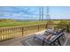 Relaxing back deck with views of a lake, featuring lounge chairs and a serene outdoor setting, perfect for entertaining at 14807 Haley Ave, Parker, CO 80134