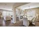 Open concept living and dining area with hardwood floors, stylish furniture, and a modern fireplace providing visual interest at 14807 Haley Ave, Parker, CO 80134
