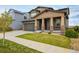 Charming two-story home with a well-manicured lawn, covered porch with stone accents, and an attached two-car garage at 14807 Haley Ave, Parker, CO 80134