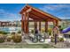 Community pavilion with picnic tables, stone accents, and a little free library at 14807 Haley Ave, Parker, CO 80134
