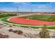 Community sports field with a running track and stadium seating at 14807 Haley Ave, Parker, CO 80134