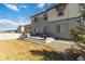 Spacious backyard with patio seating, a grassy lawn, and a stone perimeter, providing a perfect outdoor entertaining area at 12759 Buffington Trl, Parker, CO 80134