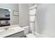 This bathroom features a shower/tub combo, gray vanity with white sink, and modern fixtures. It is well-lit and has ample space at 12759 Buffington Trl, Parker, CO 80134