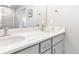 Bathroom featuring double sink vanity with white countertop and gray cabinets, large mirror, and chrome hardware at 12759 Buffington Trl, Parker, CO 80134
