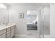 Bathroom features a glass shower and a view into the main bedroom, complete with a sleek vanity and modern design at 12759 Buffington Trl, Parker, CO 80134