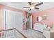 Lovely Bedroom with pink walls, a white dresser, and a crib, designed to provide a calm and soothing atmosphere at 12759 Buffington Trl, Parker, CO 80134