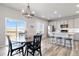Bright dining area featuring stylish chandelier and views of the expansive landscape through a sliding glass door at 12759 Buffington Trl, Parker, CO 80134