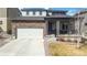 Attractive two-story home showcasing a stone facade, inviting porch, and two-car garage at 12759 Buffington Trl, Parker, CO 80134