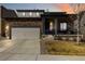 Attractive two-story home showcasing a modern design with stone accents and a well-maintained lawn at 12759 Buffington Trl, Parker, CO 80134