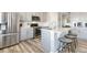 Modern kitchen with stainless steel appliances, gray cabinetry, quartz countertops, and a breakfast bar at 12759 Buffington Trl, Parker, CO 80134