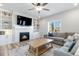 Comfortable living room featuring a fireplace, built-in shelves, ample natural light and neutral colors at 12759 Buffington Trl, Parker, CO 80134