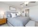 Main bedroom features an upholstered headboard, and light gray walls. Modern accents add to the charm of this comfortable bedroom at 12759 Buffington Trl, Parker, CO 80134